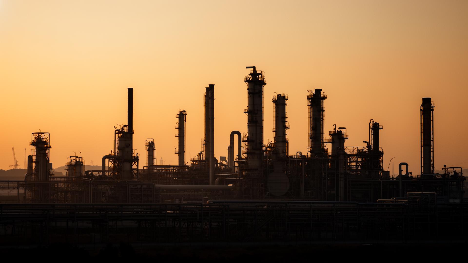 Industrial smelter processing metal alloys at golden hour